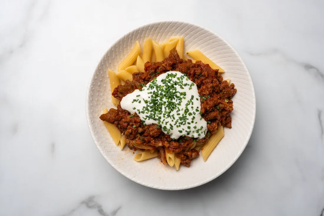 A bowl of pasta with ragù, from above
