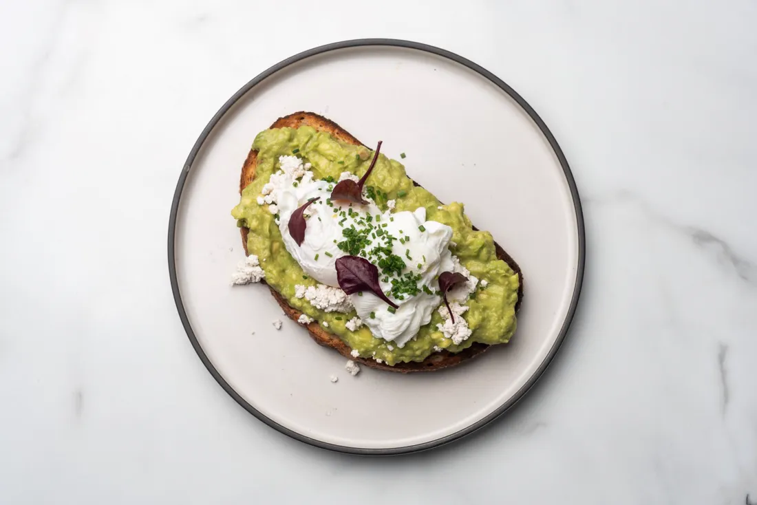 Smashed avocado and poached eggs on toast, from above