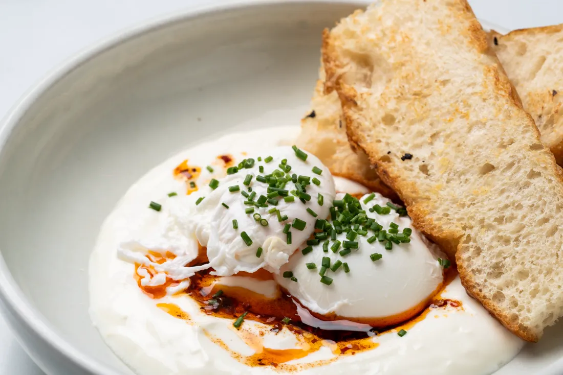 Poached eggs with labne, chilli oil and toast
