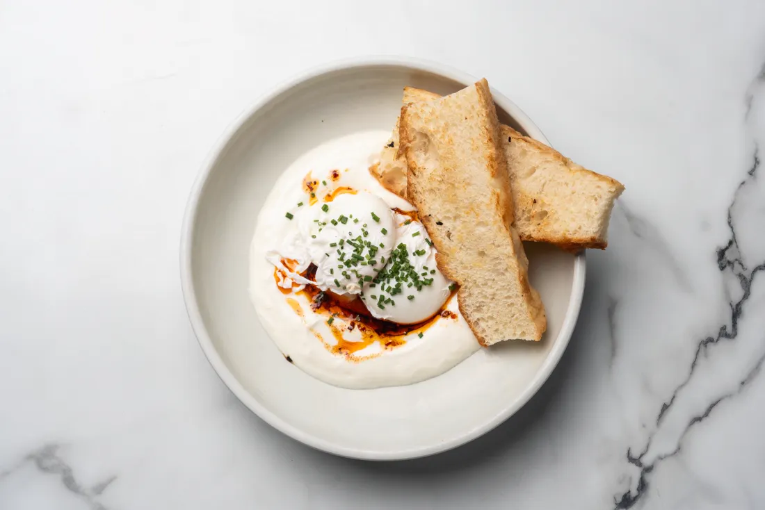 Poached eggs with labne and toast, from above