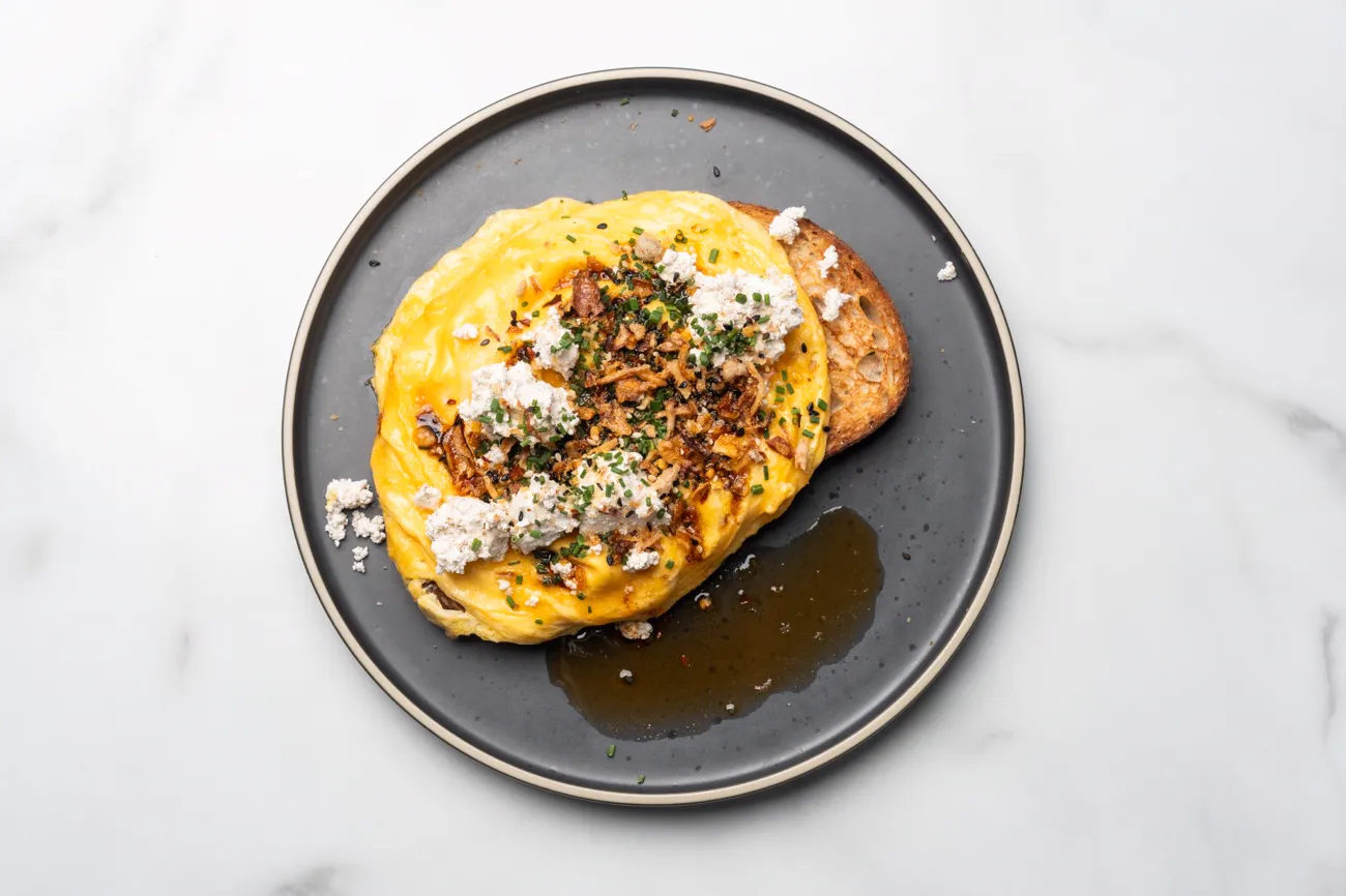 Eggs on toast with crumbled feta and herbs